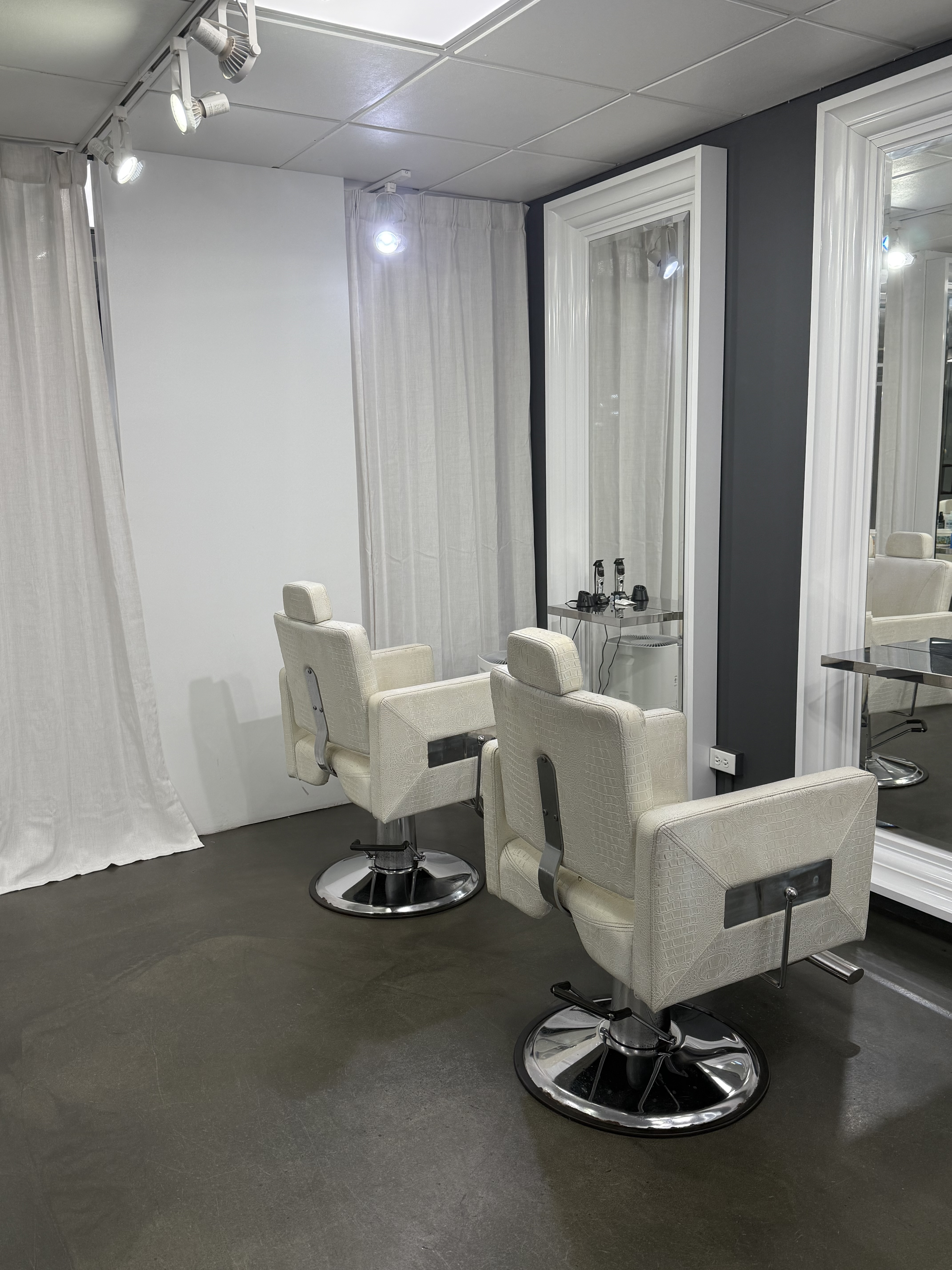 Salon station with two chairs and mirrors